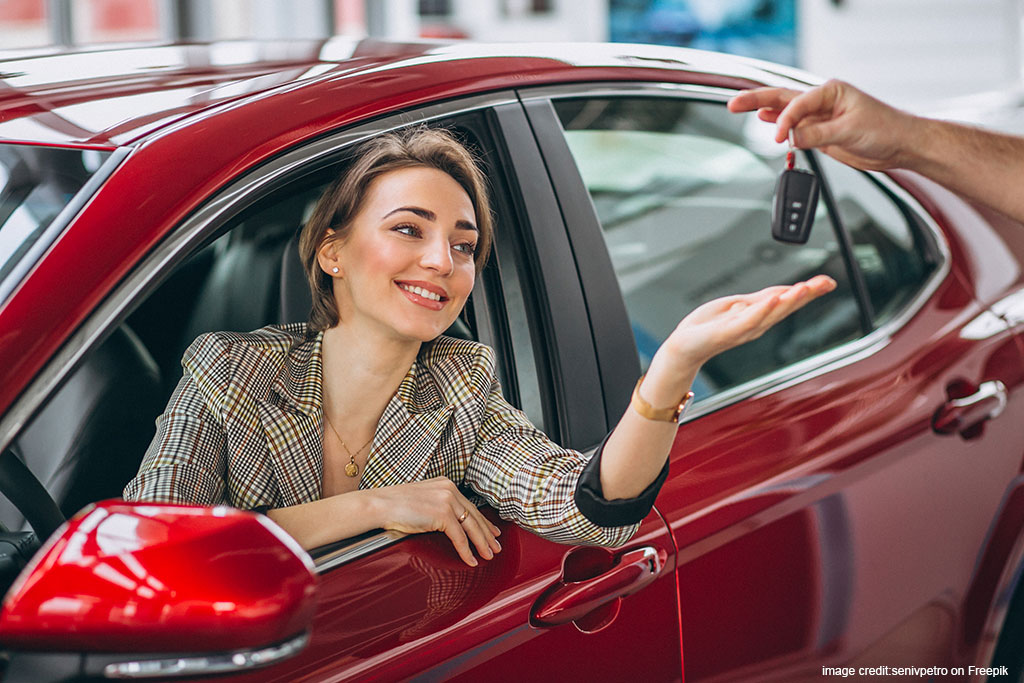 woman-sitting-red-car-receiving-keys2.jpg